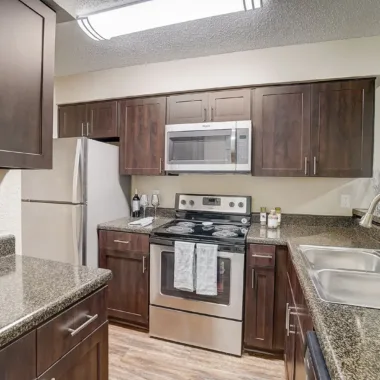 Open kitchen with stainless appliances at Willowbrooke Apartments in Lakeland, FL
