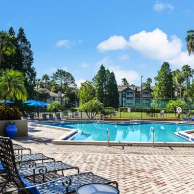 Pool lounge seating on sundeck at Willowbrooke Apartments in Lakeland, FL