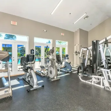 Fitness center overlooking pool at Willowbrooke Apartments in Lakeland, FL
